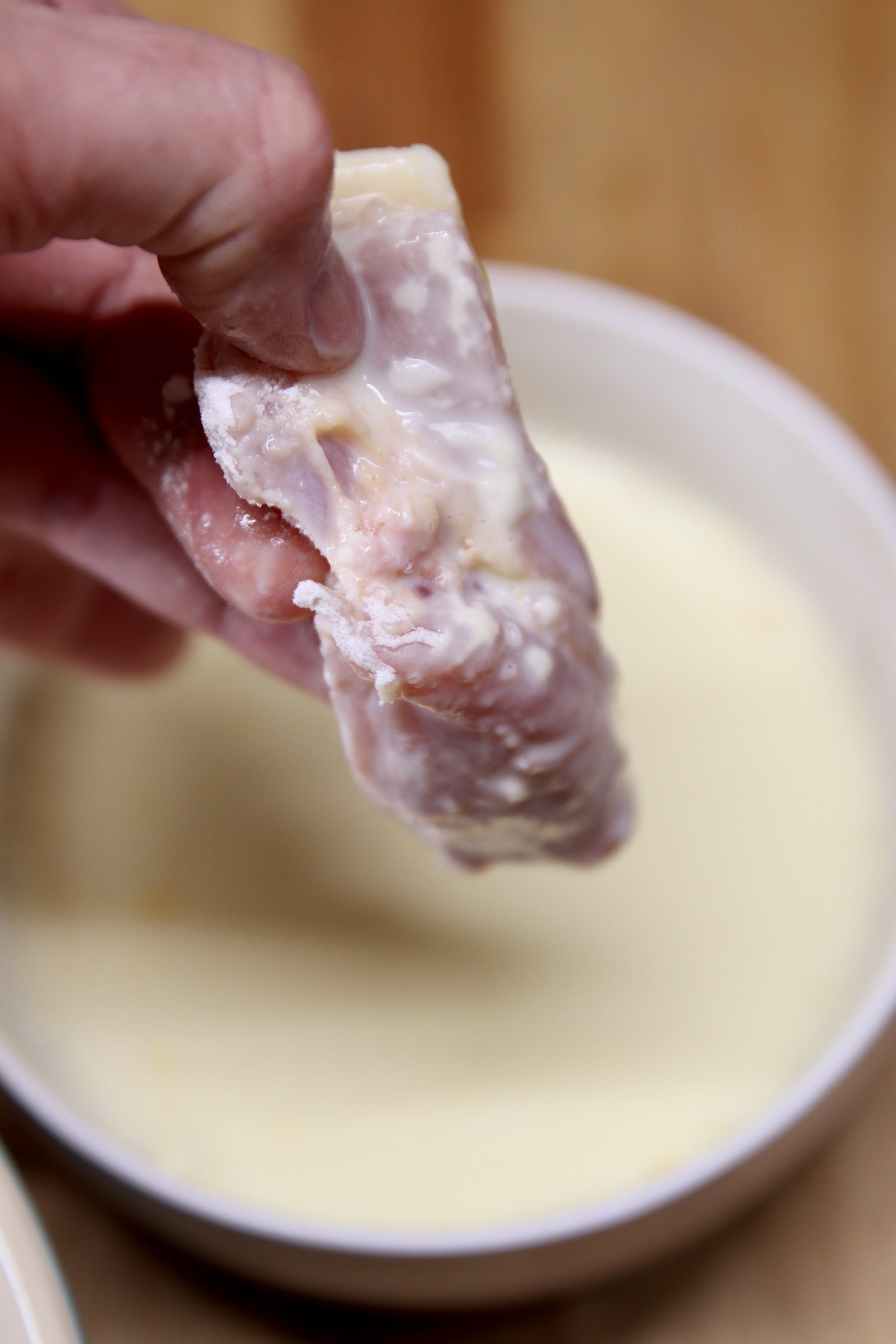 chicken piece dipped in egg and milk batter