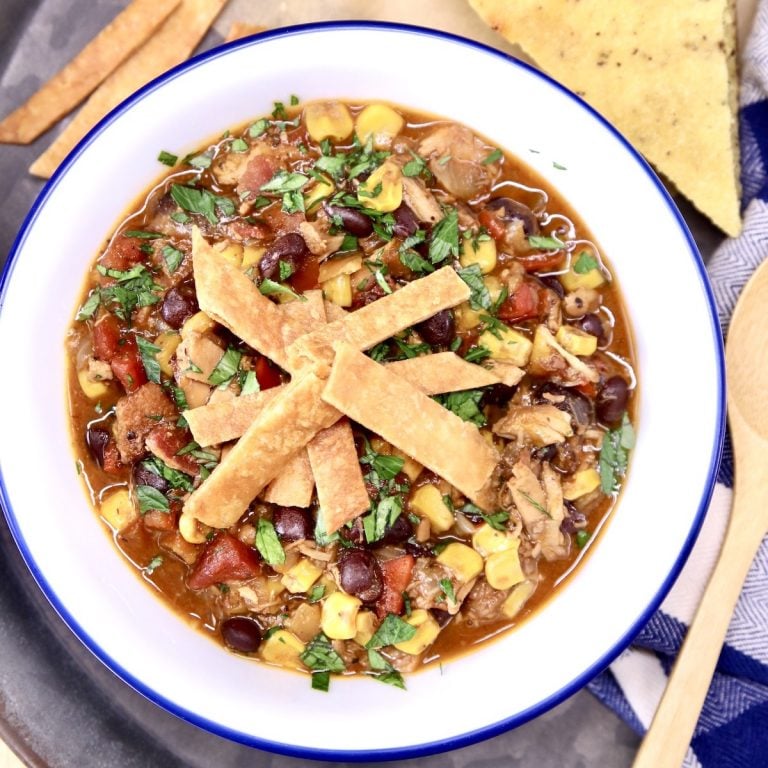 Chicken tortilla soup in a bowl topped with crispy tortilla strips