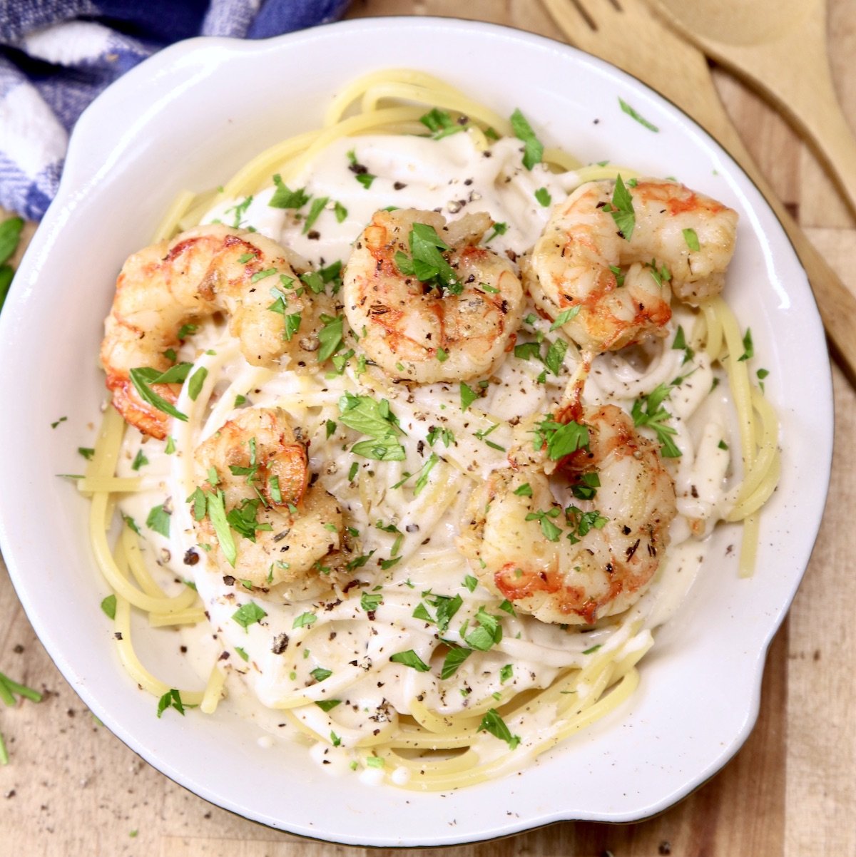 bowl of spaghetti with creamy sauce topped with shrimp