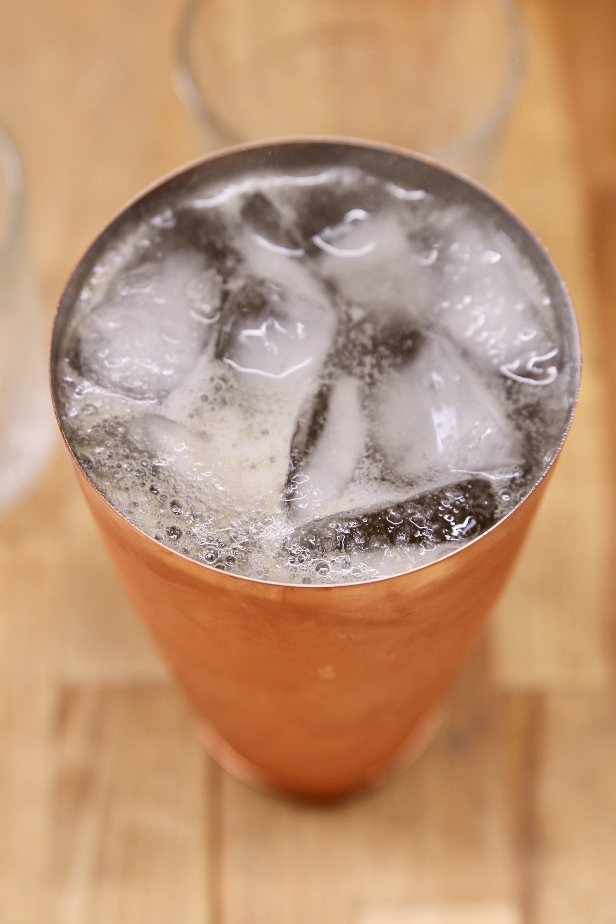 cocktail shaker filled with whiskey smash