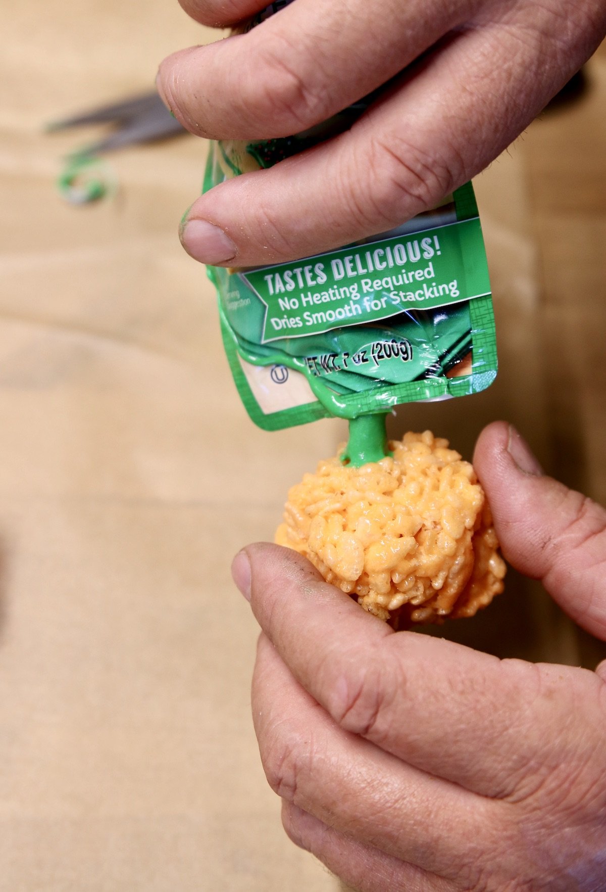 Decorating pumpkin rice krispie treats with icing