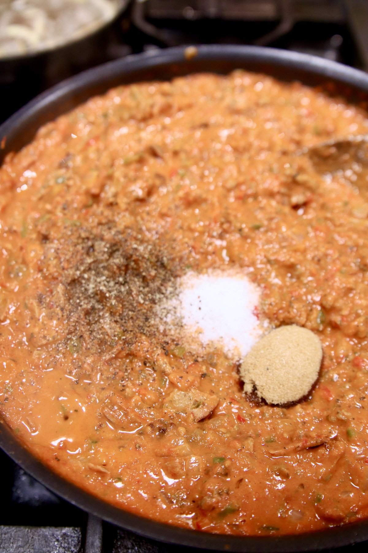 meat sauce, adding salt, pepper, brown sugar