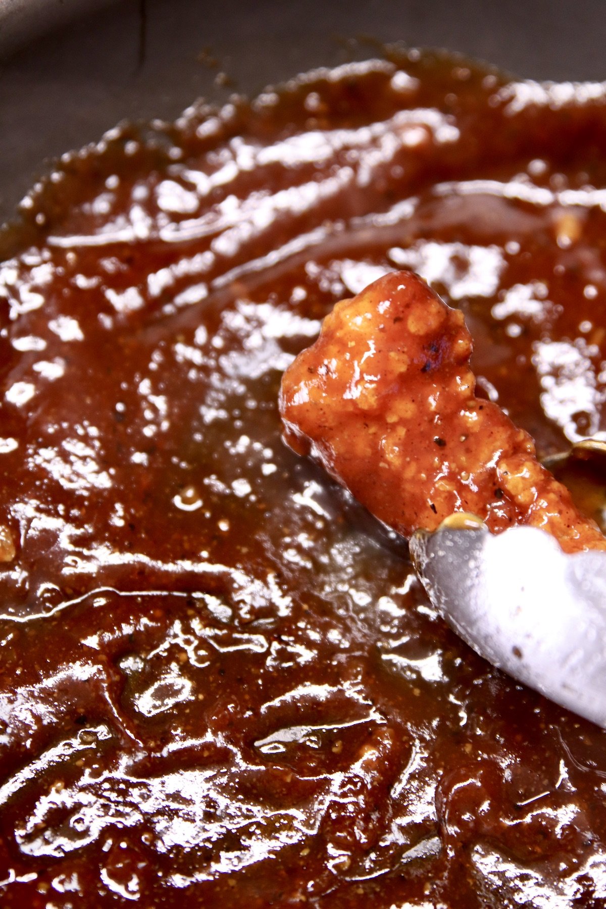 dipping fried chicken in bbq sauce