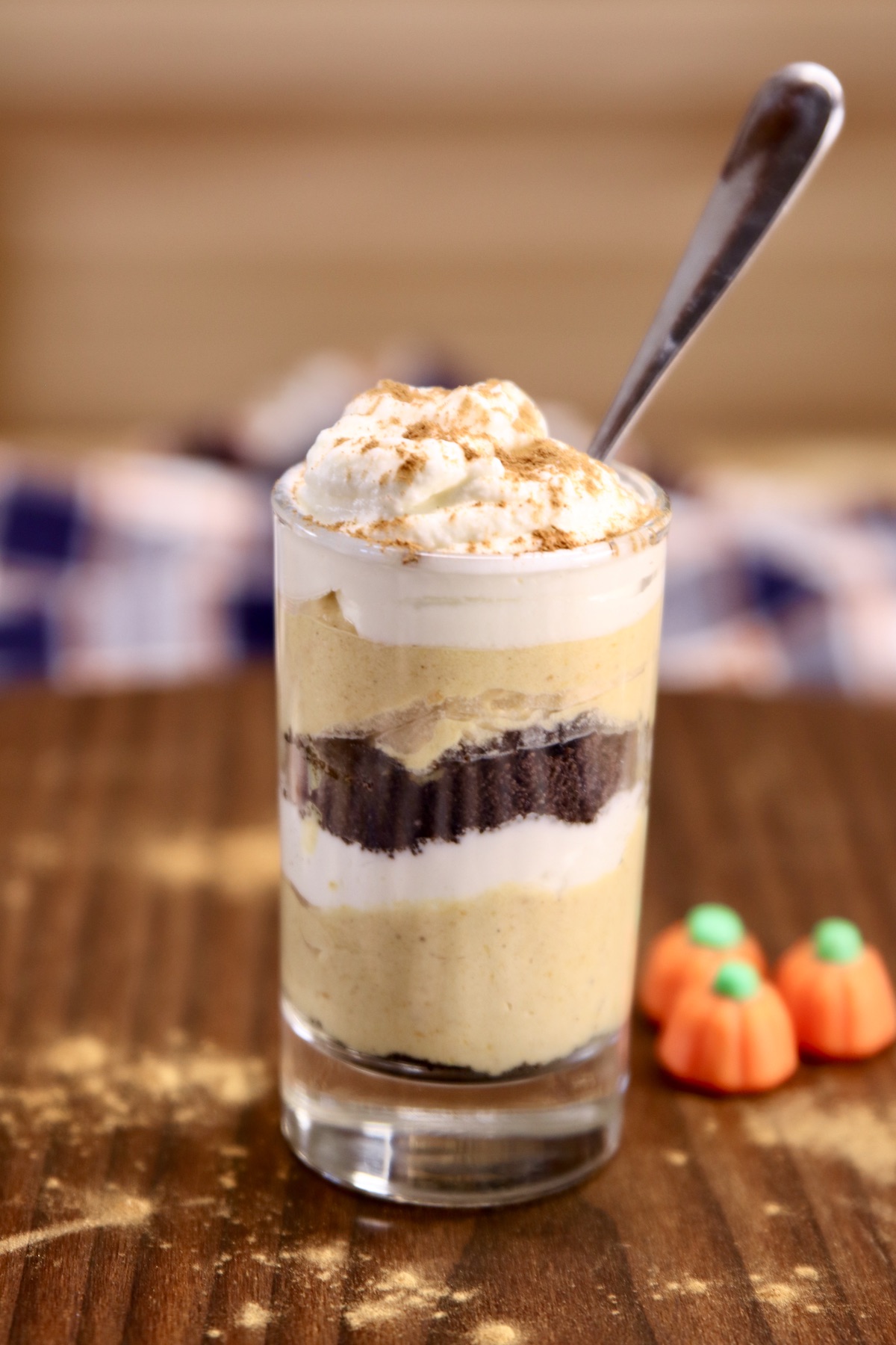 pumpkin cheesecake in a small glass with a dessert spoon