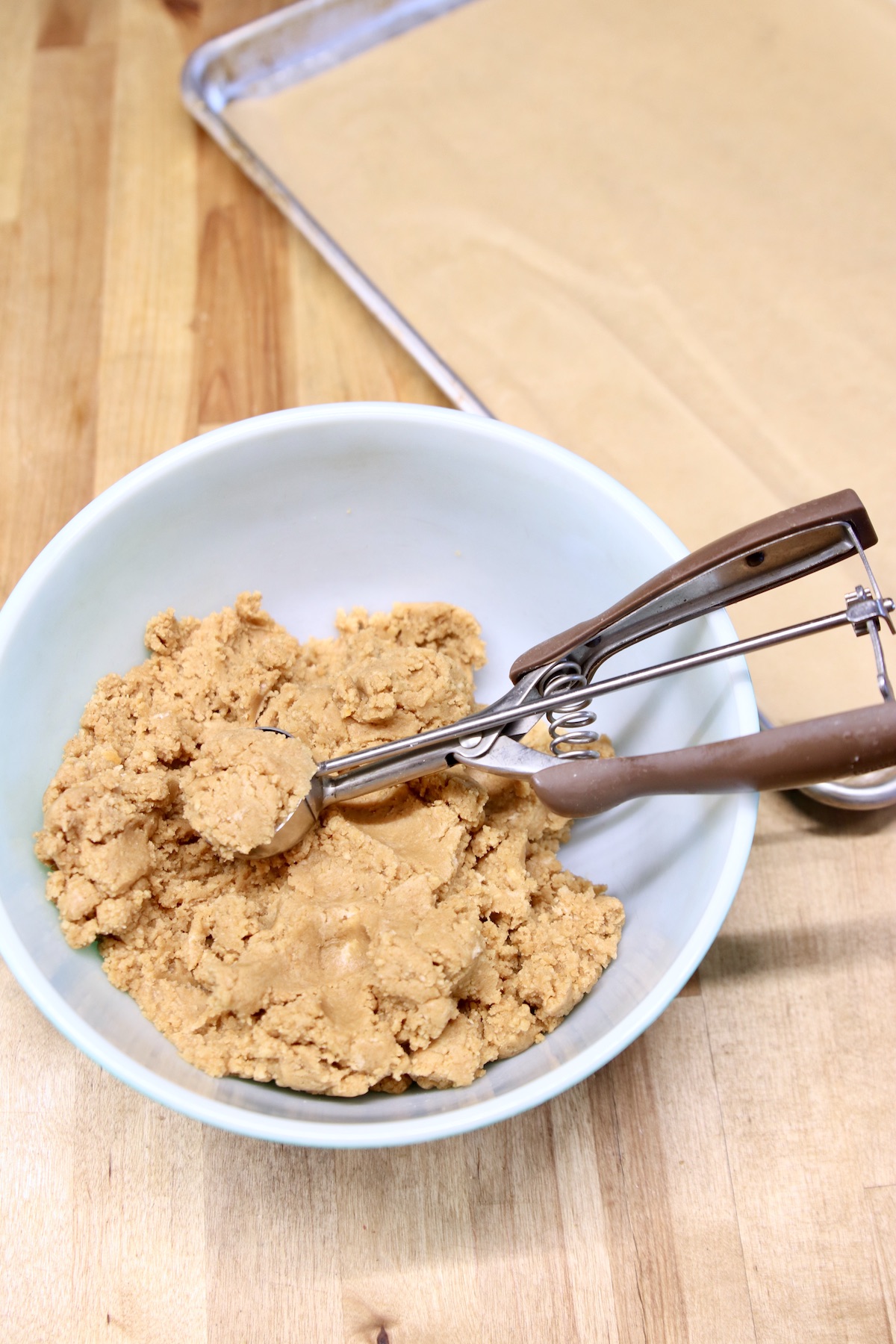 bowl of cookie ball truffle filling with a cookie scoop