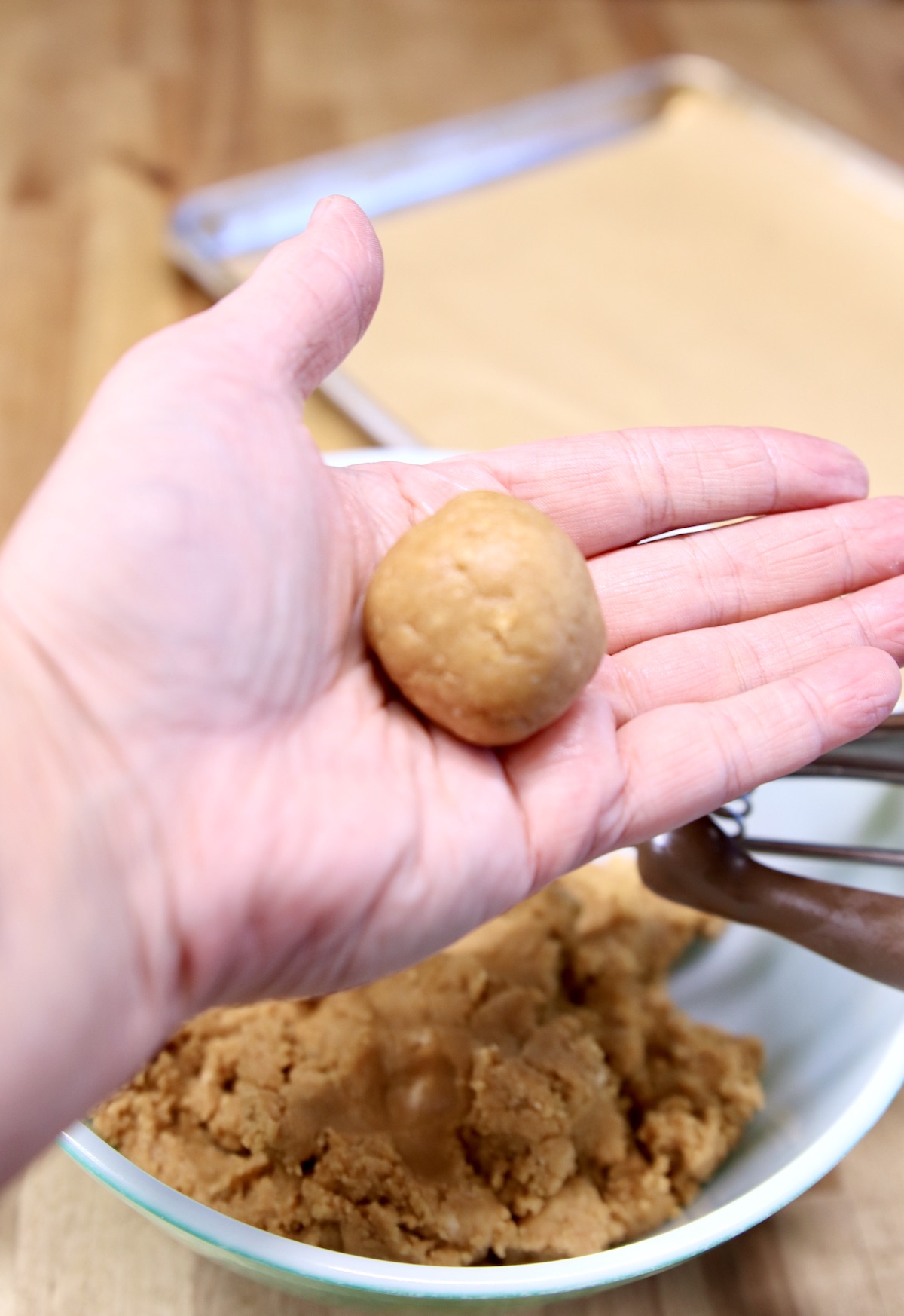 hand holding peanut butter cookie ball