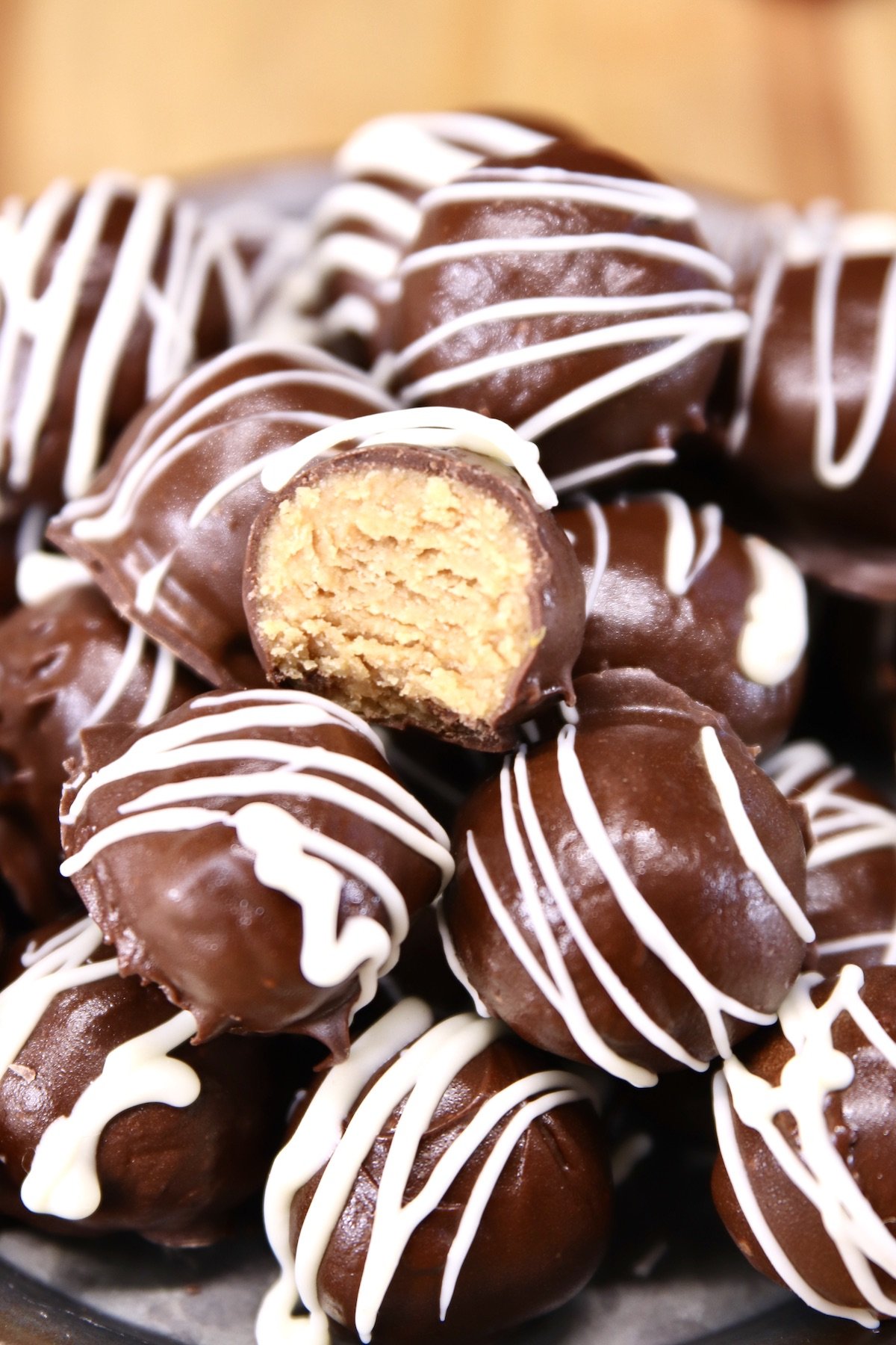 peanut butter truffles in a bowl, one sliced in half