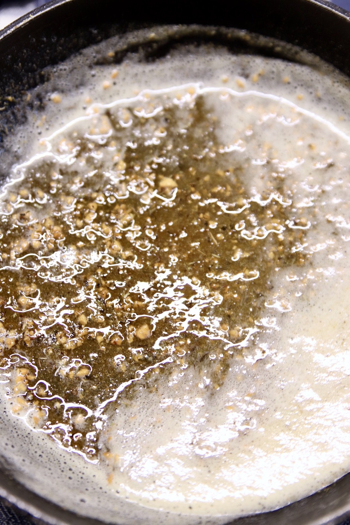 garlic butter in a skillet with herbs