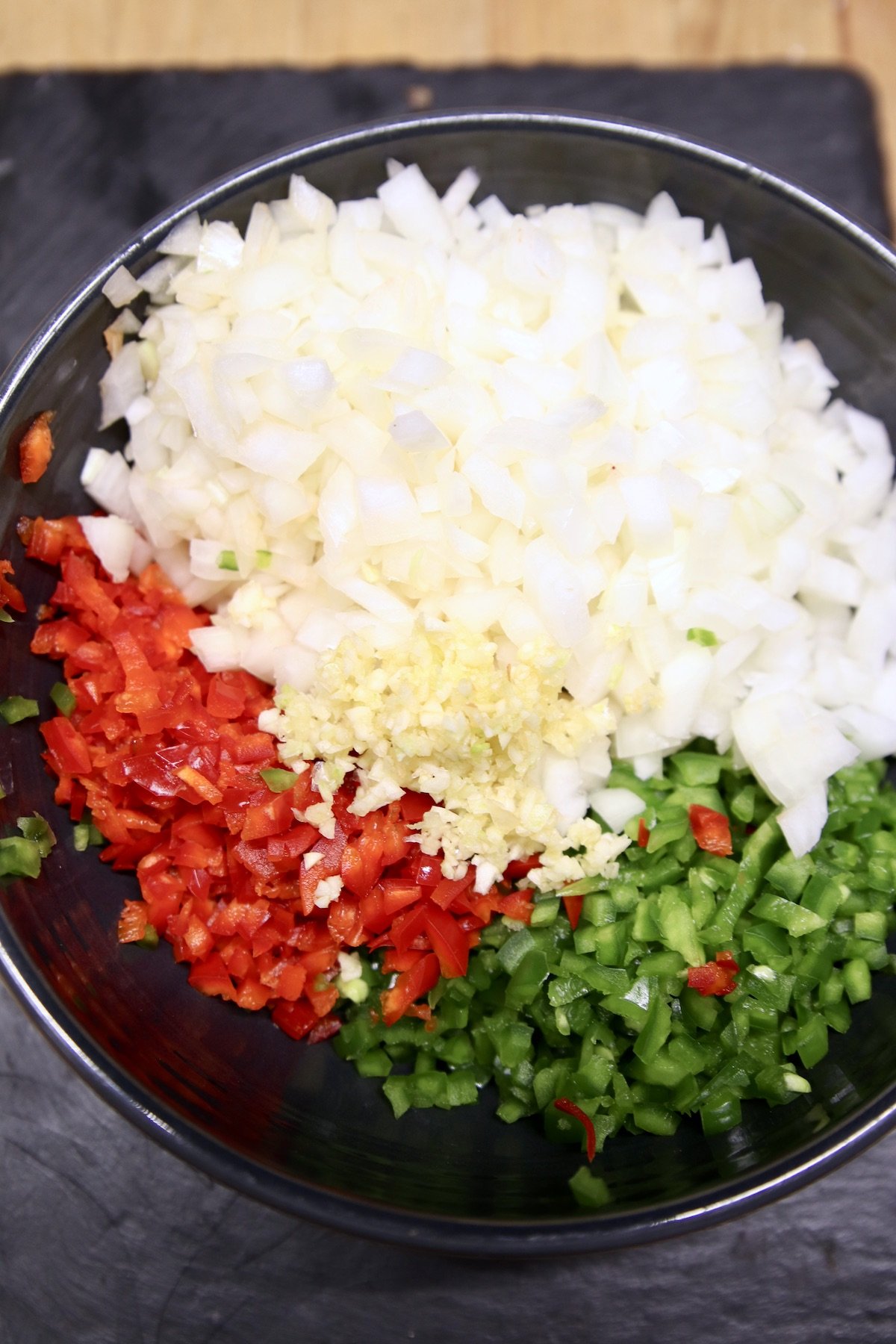 skillet with onions, bell peppers, garlic