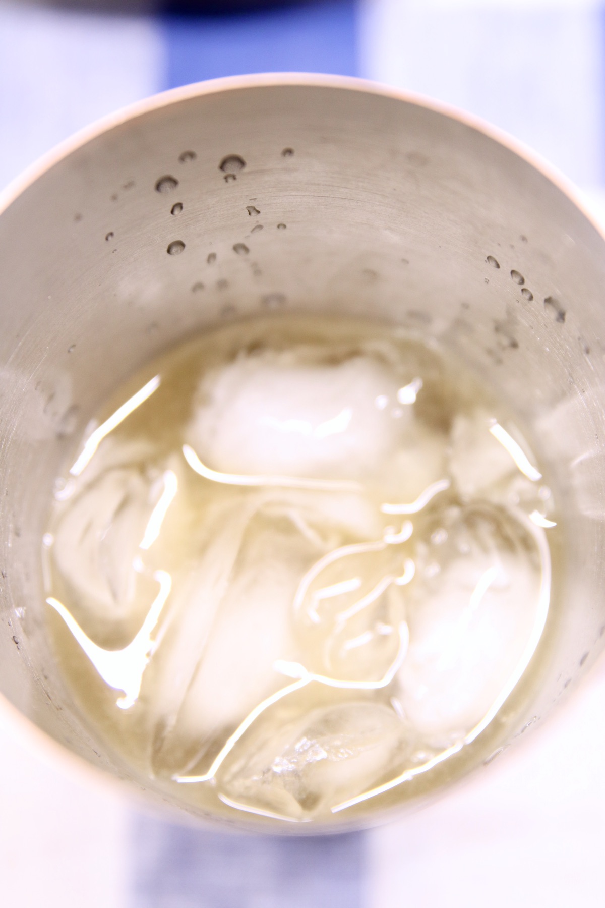 cocktail shaker with ice and ingredients for daisy cocktail