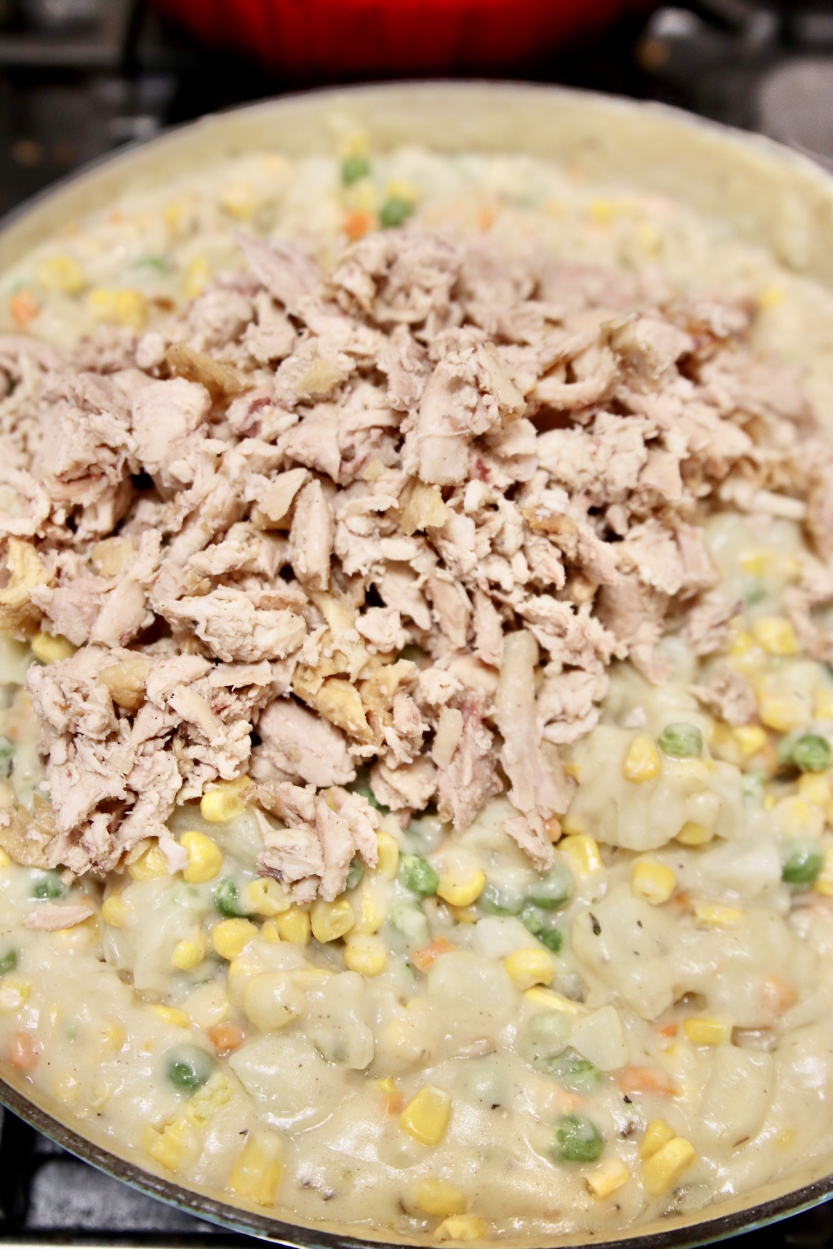 adding chicken to pot pie filling
