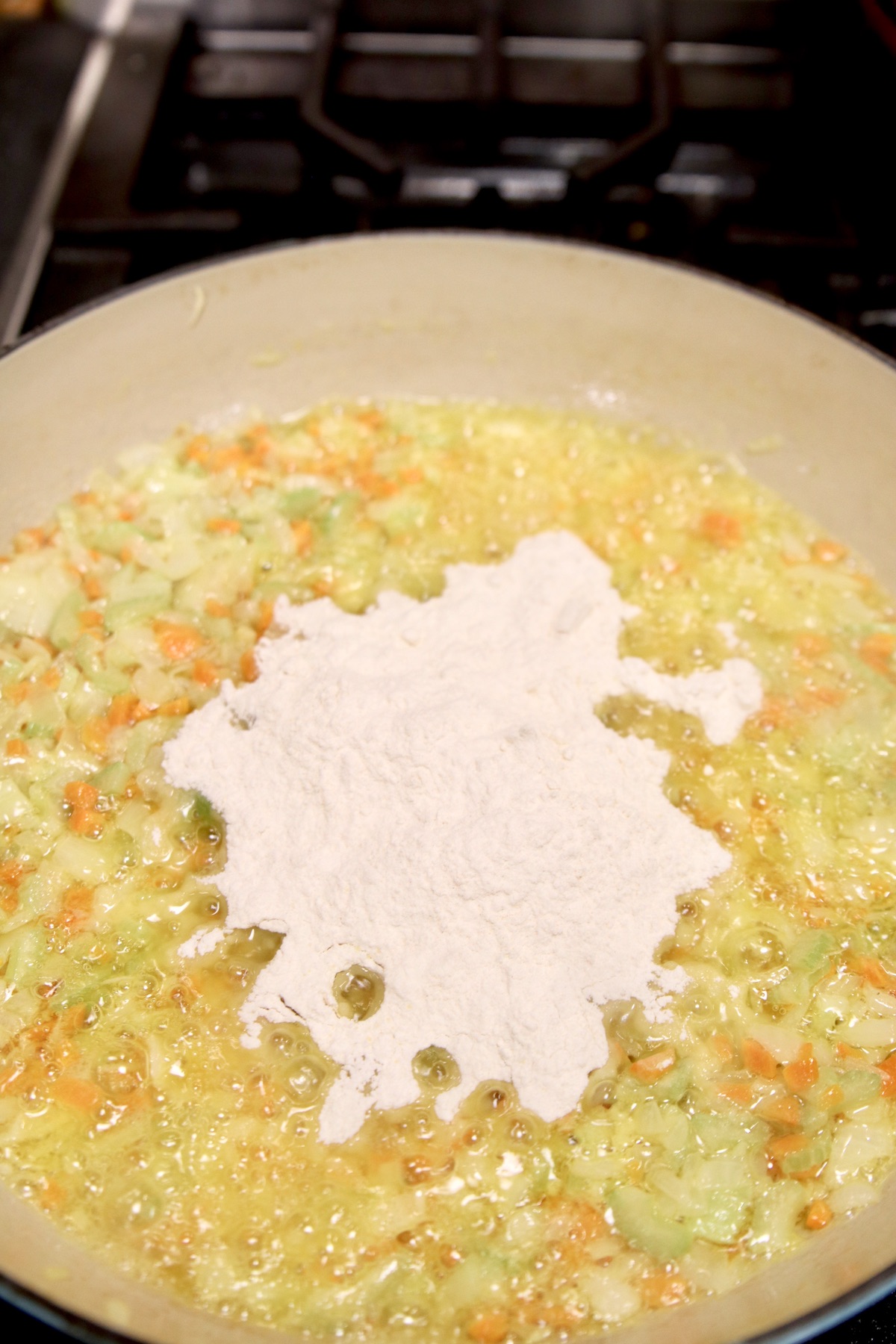adding flour to chicken pot pie sauce