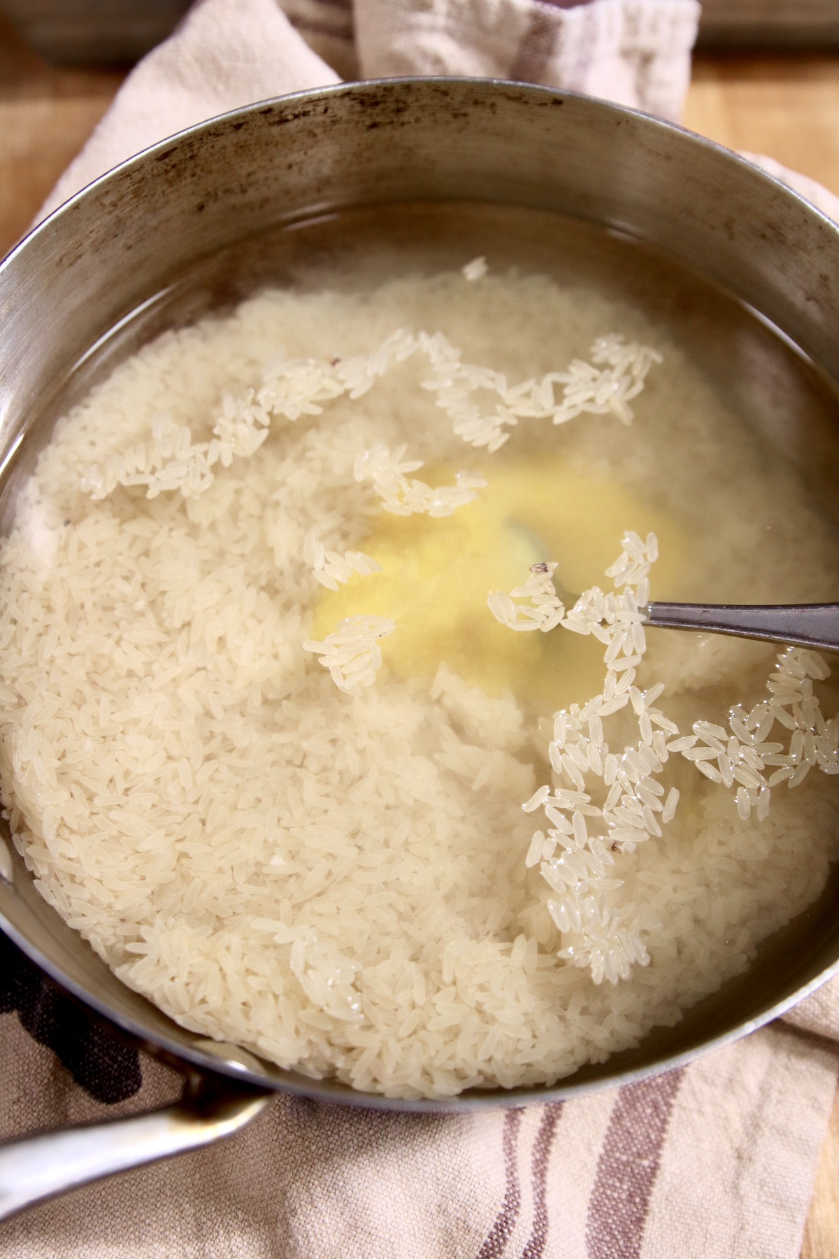 rice, water and chicken base in a pan