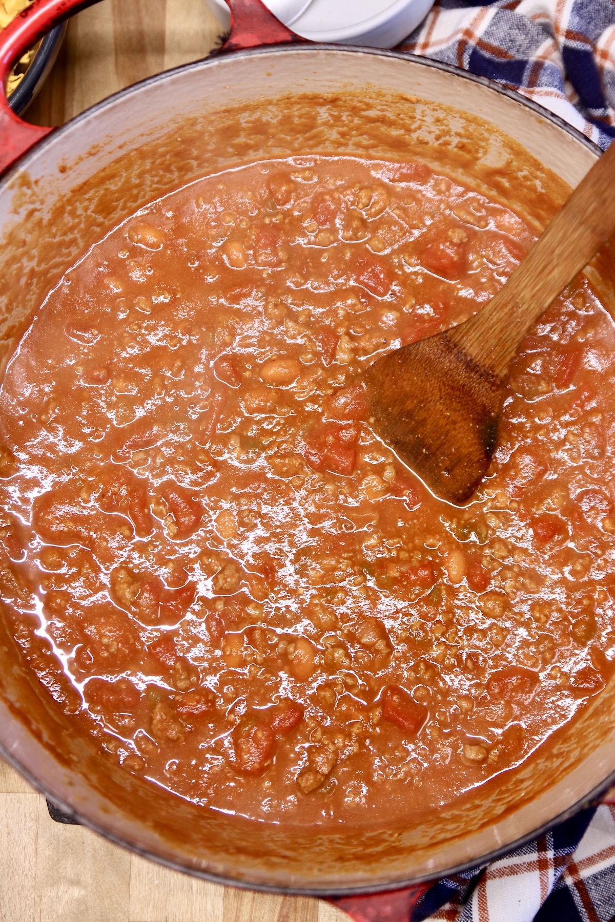 pot of chili with wooden spoon