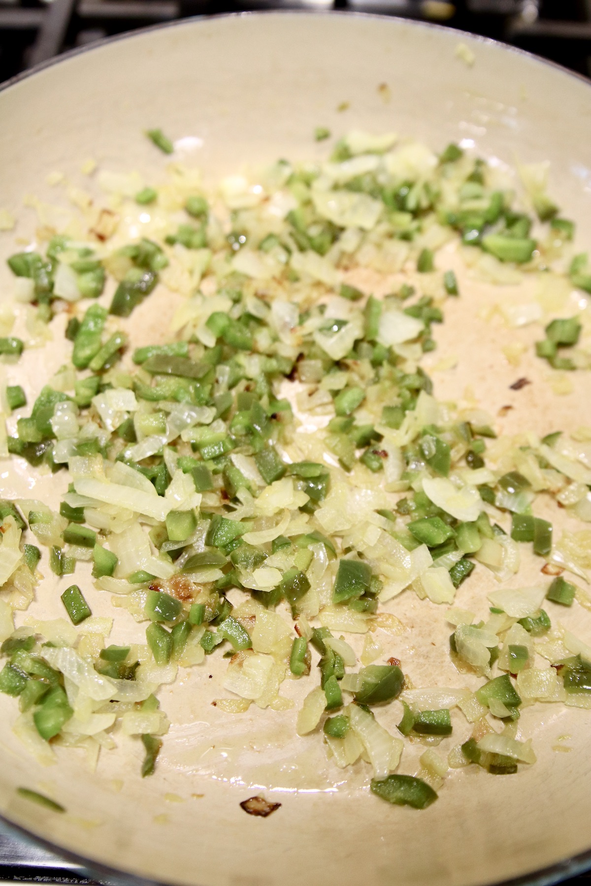 cooking pepper and onions in a pan