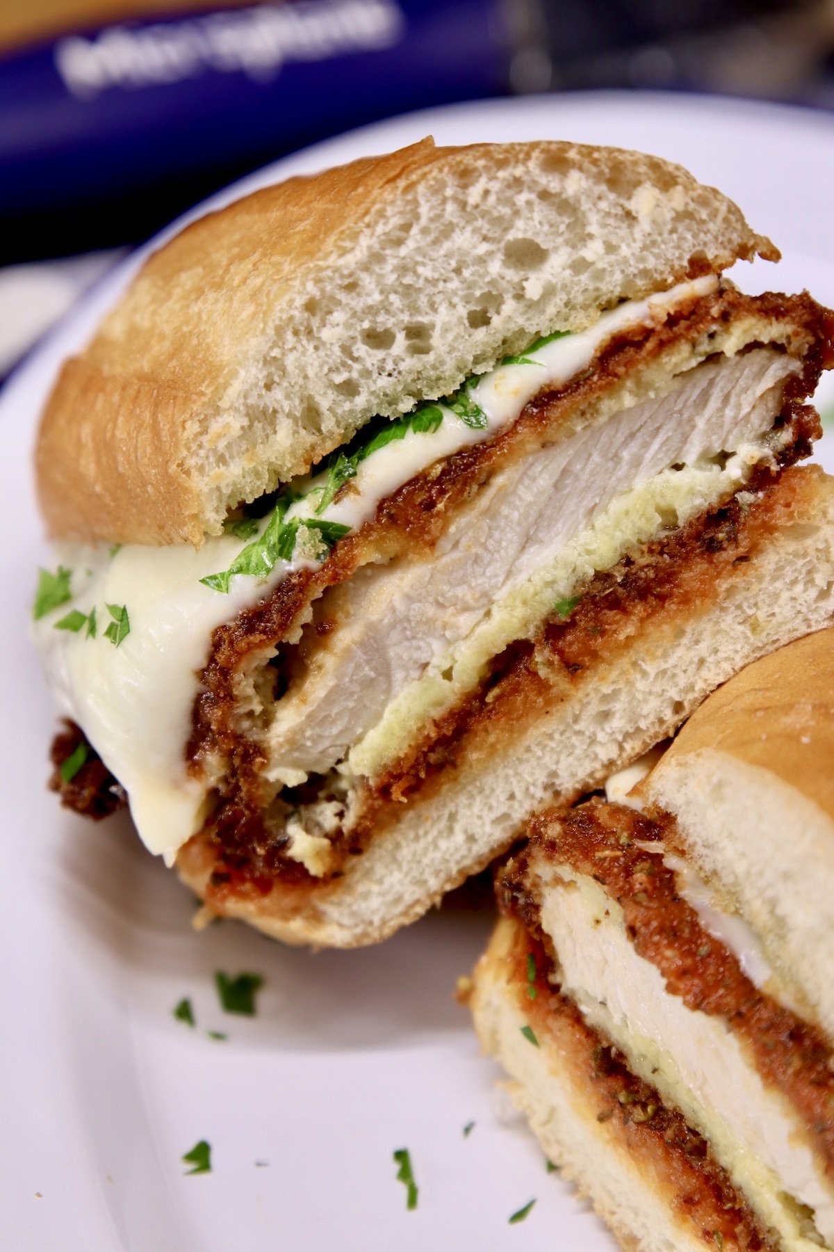 chicken parmesan sandwich sliced in half