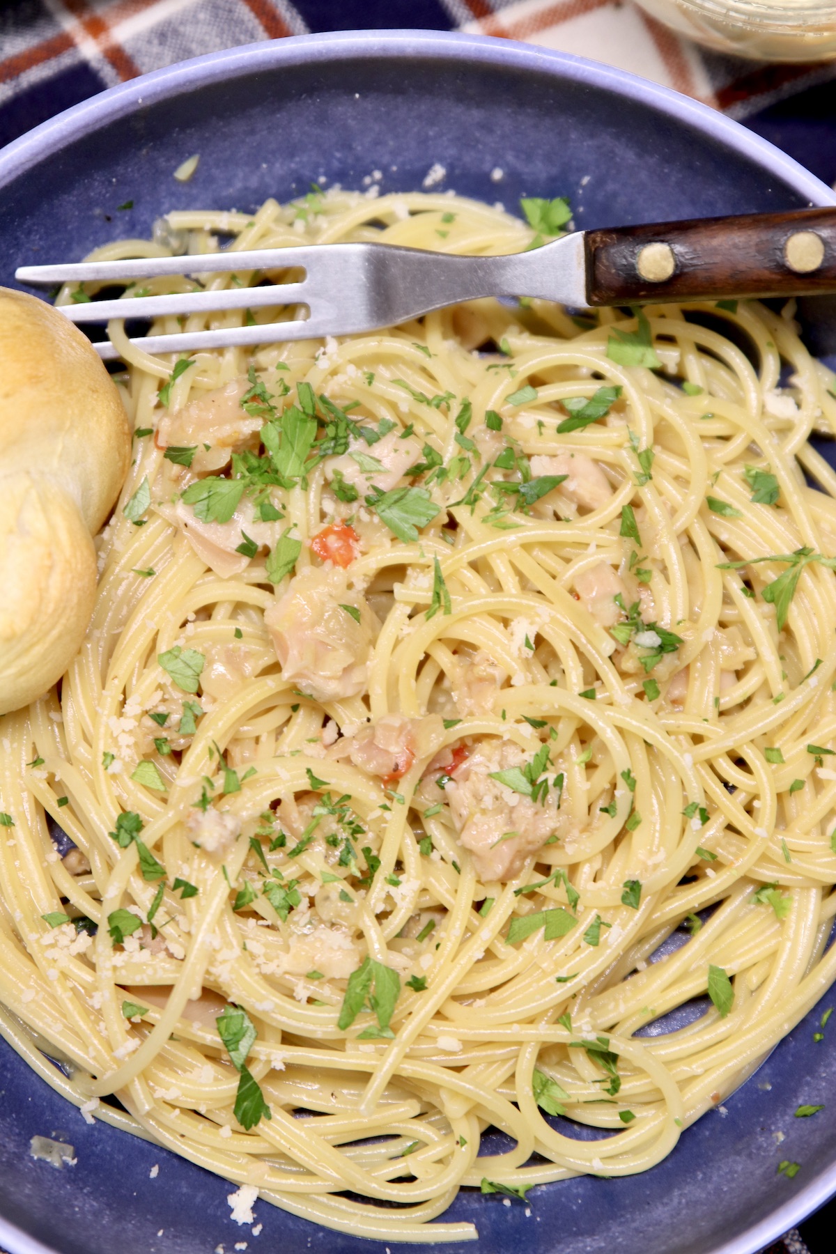 spaghetti with clam sauce in a bowl with a fork