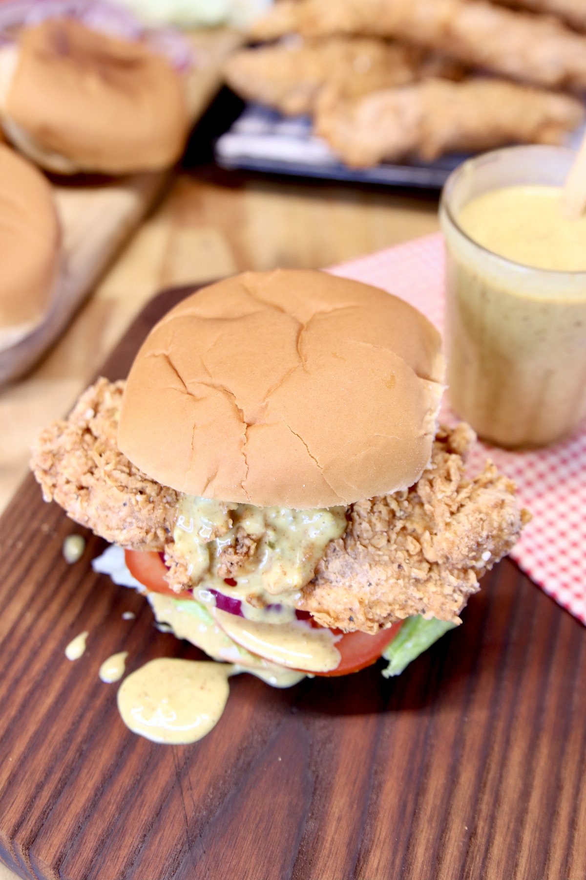 chicken tender sandwich with chicken in back ground