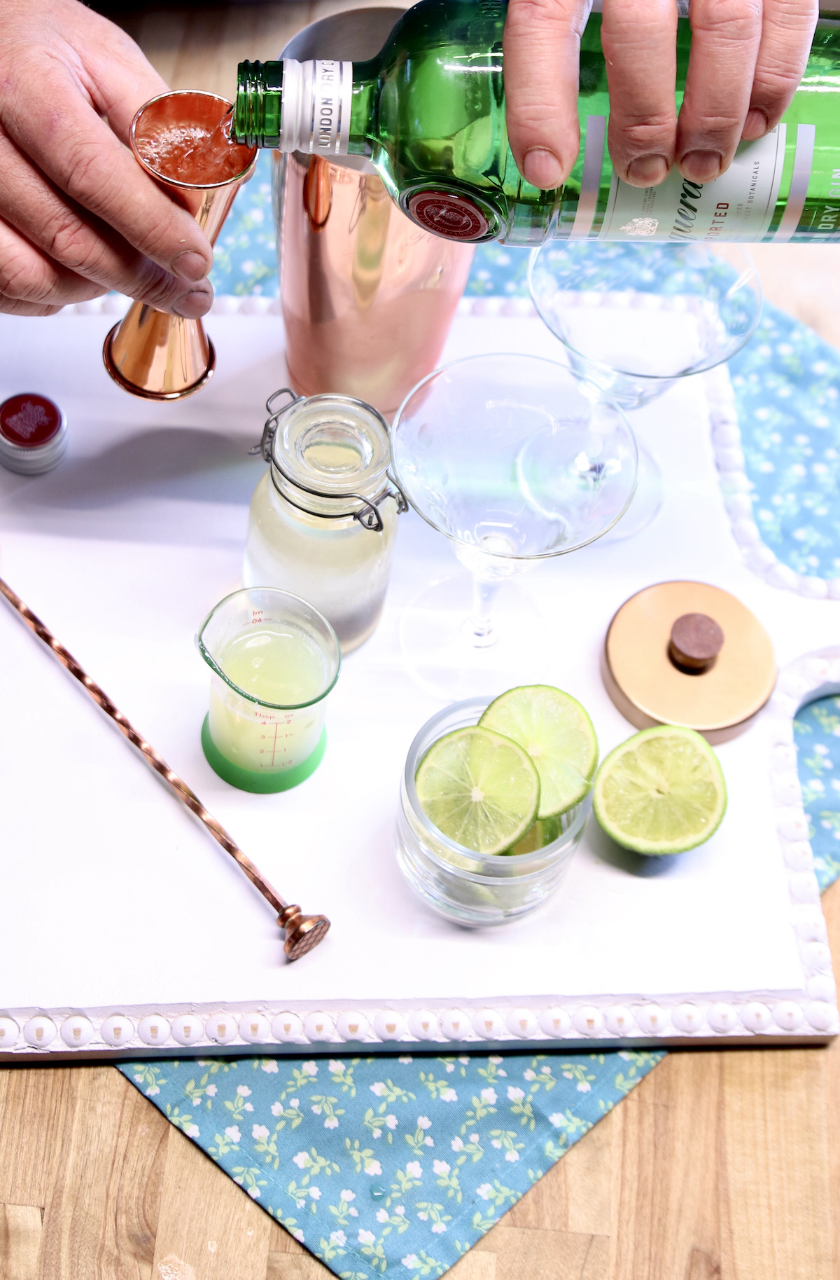 measuring gin for a gimlet cocktail