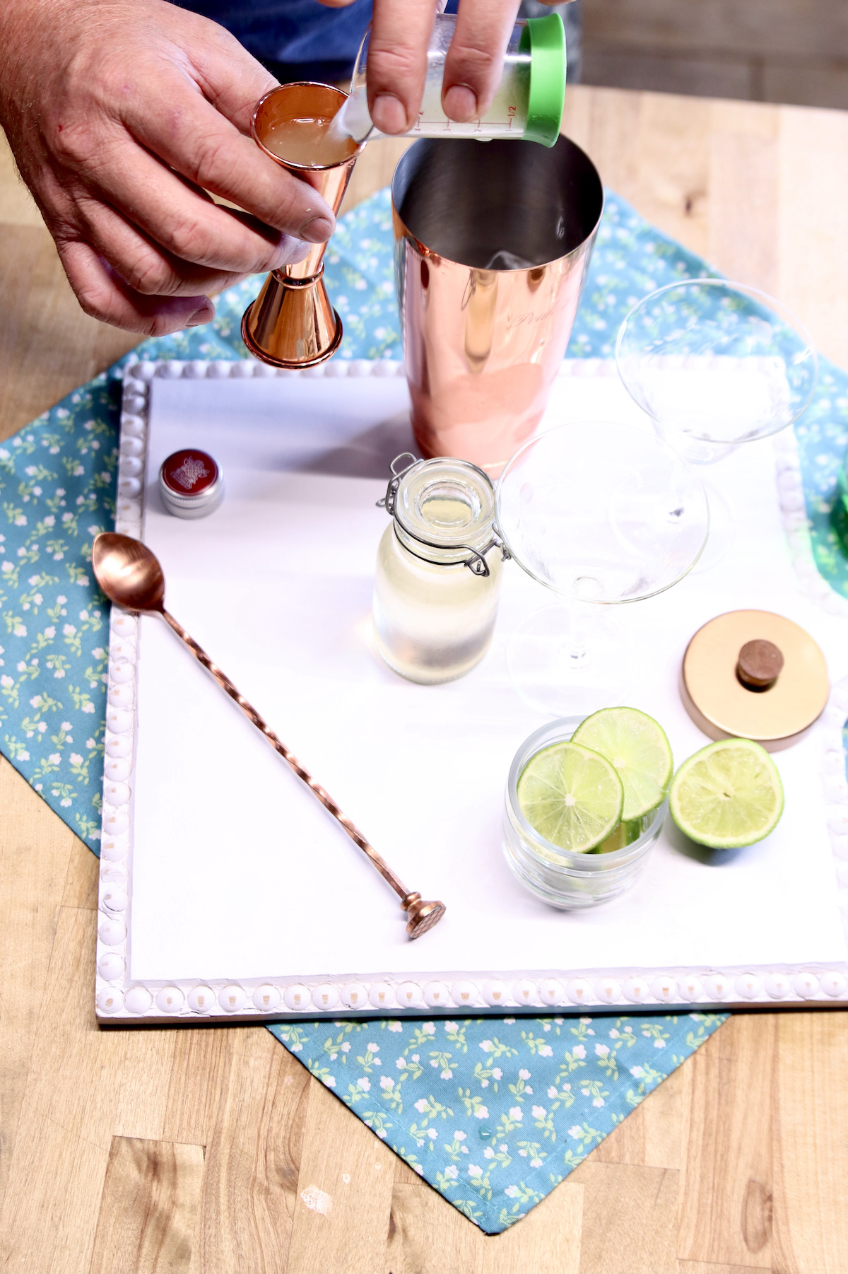 measuring lime juice for gimlet