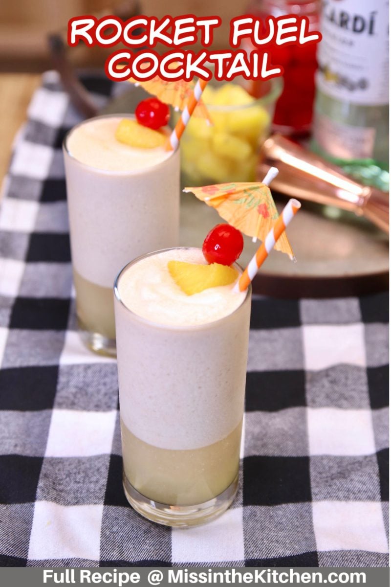 rocket fuel cocktails - 2 collins glasses, cherry & pineapple garnish.