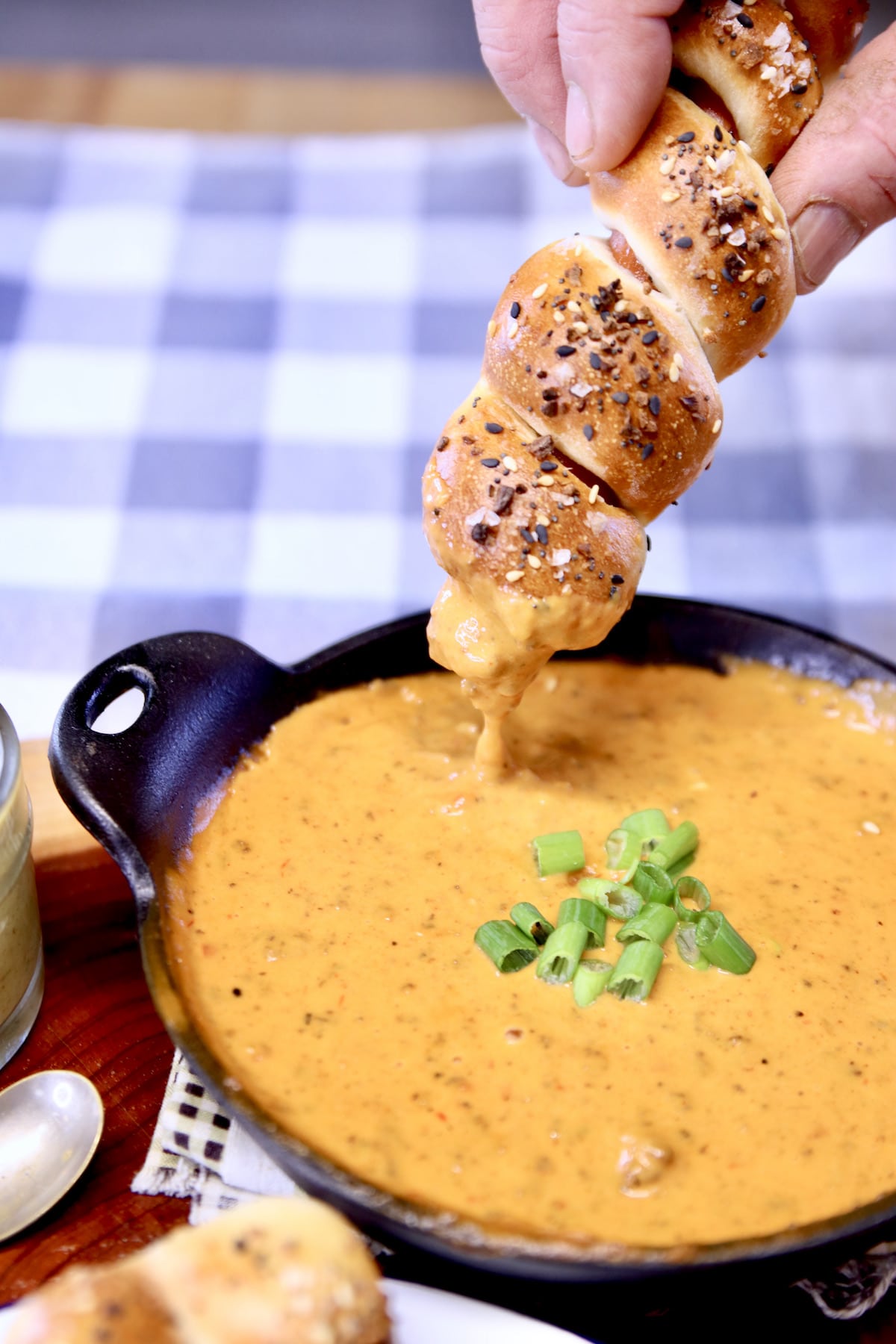 pretzel dog dipping into cheese dip