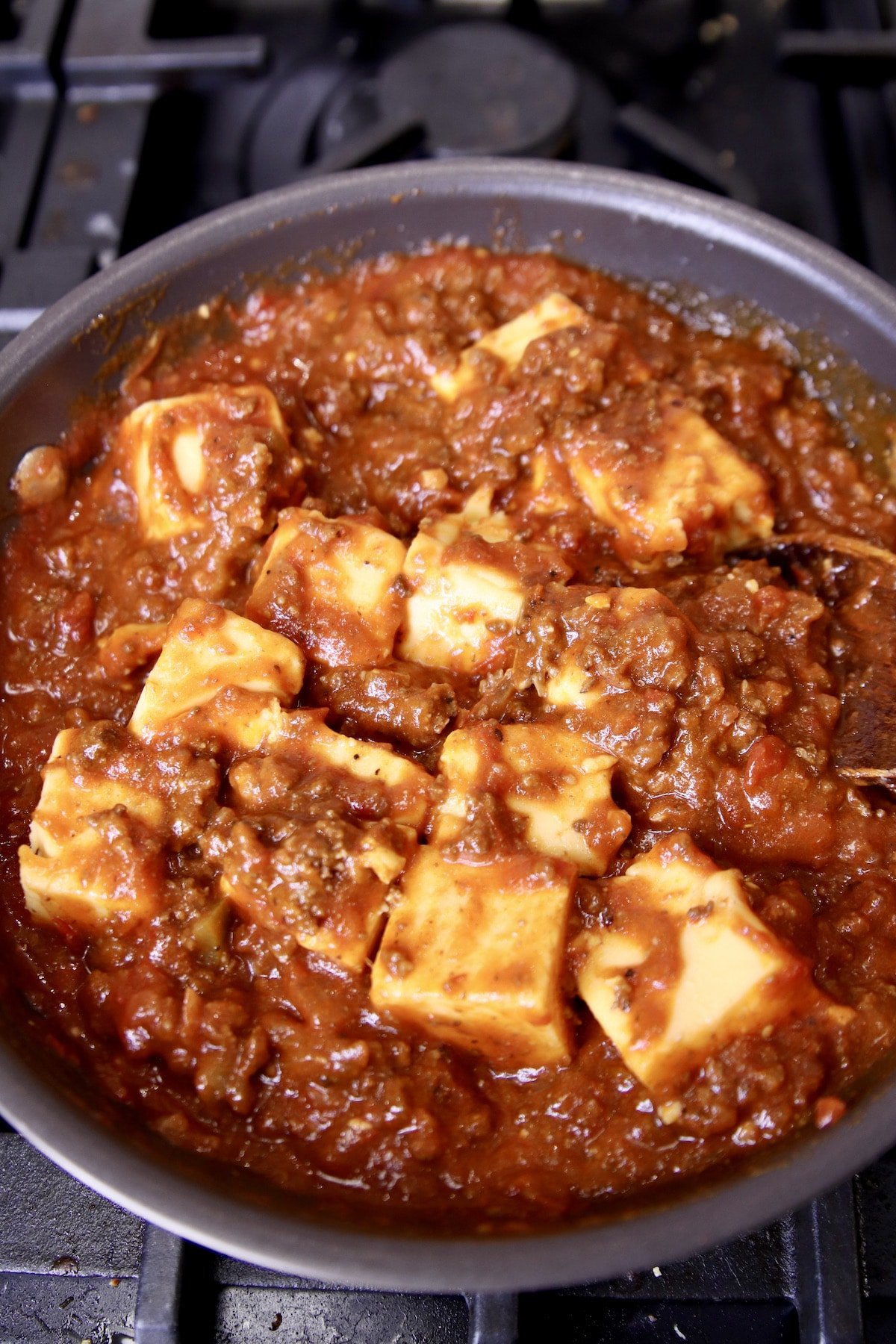 cooking chili cheese dip in a pan.