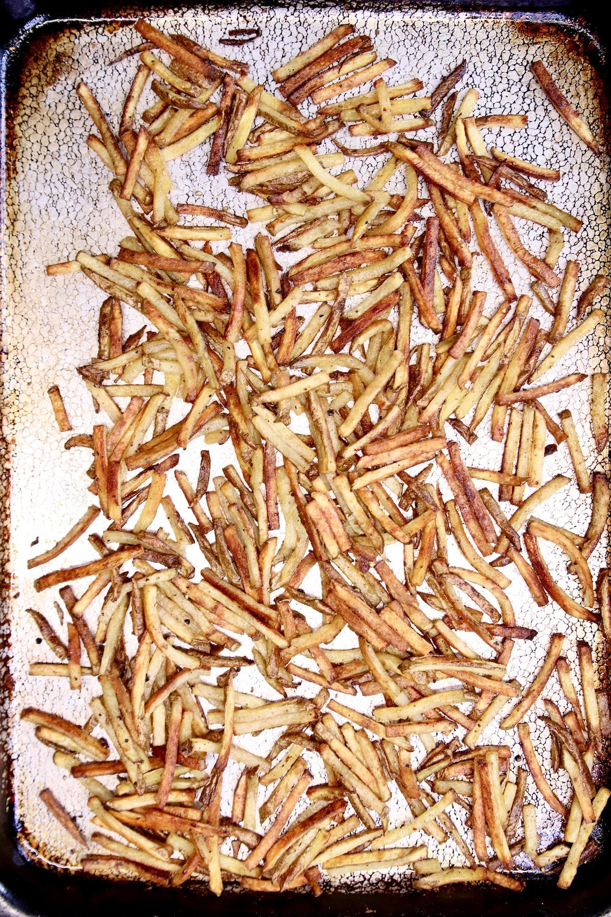 crispy baked fries on a sheet pan.