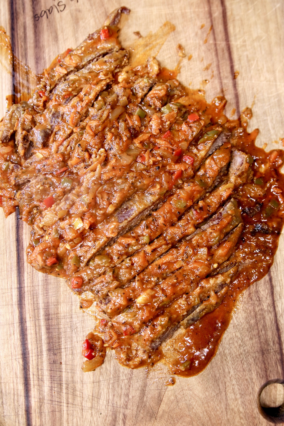 sliced Swiss steak on a cutting board