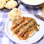 plate of Swiss steak over mashed potatoes