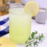 lemonade in a glass with a lemon wheel garnish.