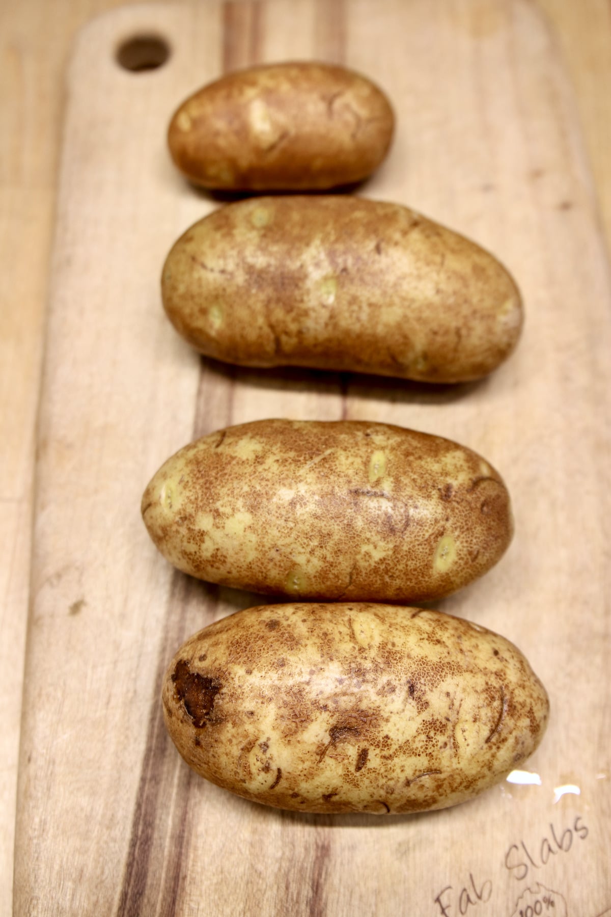 russet potatoes on a cutting board