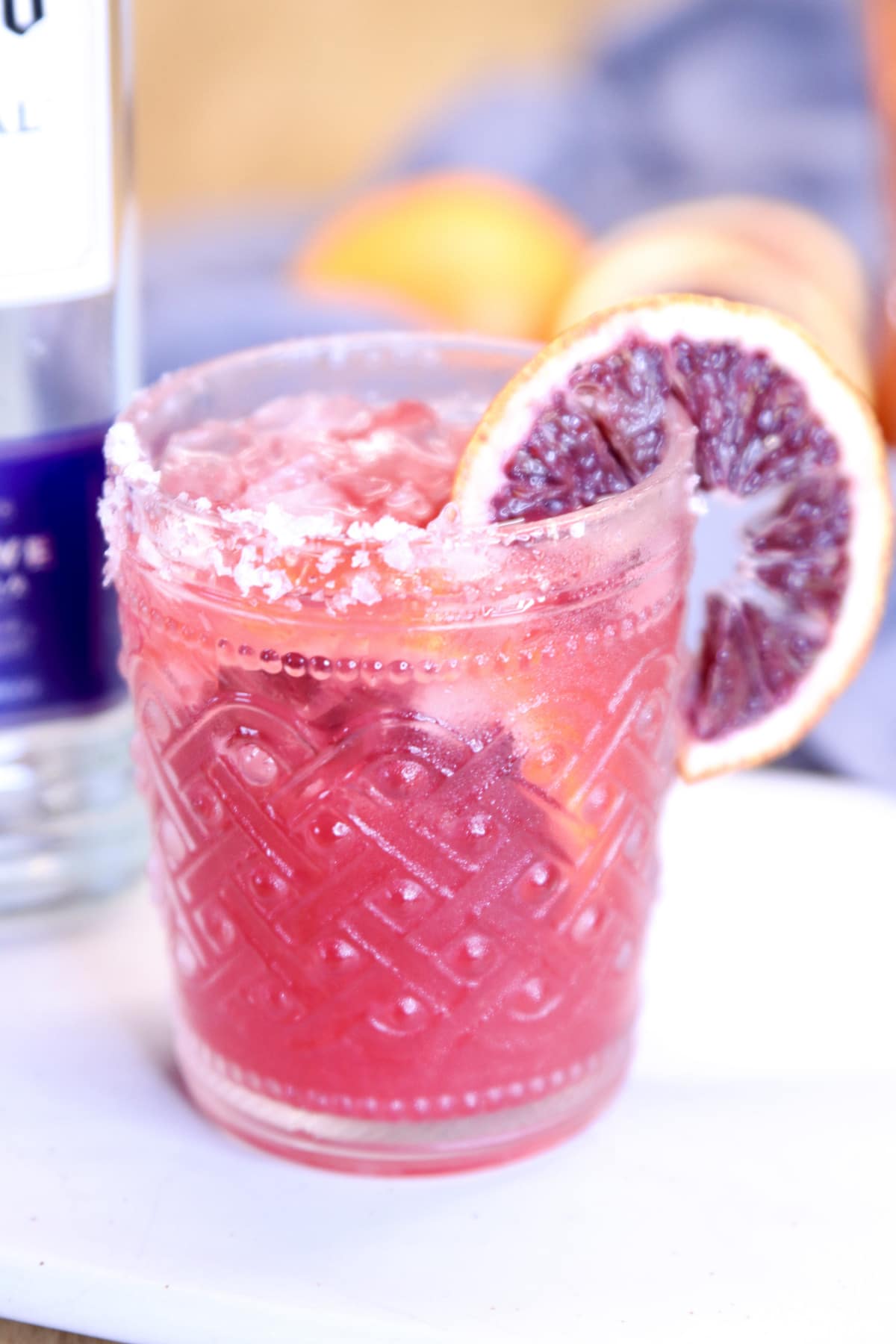 blood orange cocktail with orange garnish.