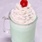 Boozy Shamrock Shake with whipped cream and cherry.