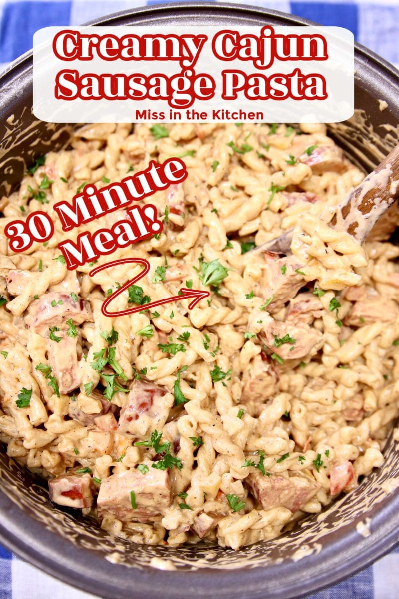 Creamy Cajun Sausage Pasta in a pan- text overlay.
