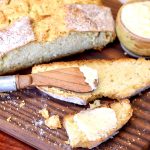 Slice of Irish Soda bread with butter & knife.