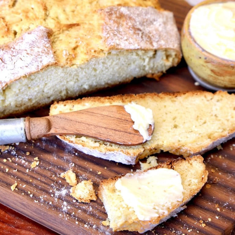 Slice of Irish Soda bread with butter & knife.