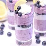 dessert glass with layered blueberry cheesecake.
