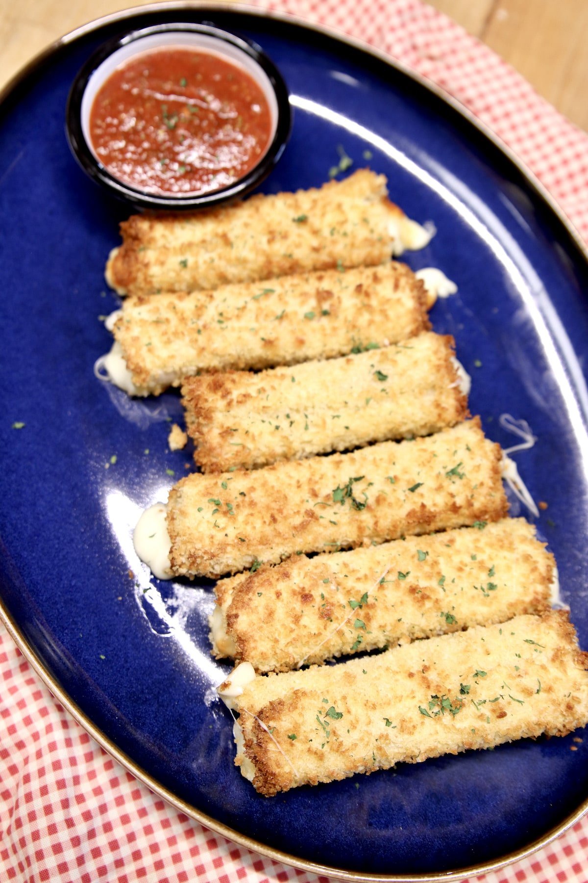 Platter of homemade grilled cheese sticks with marinara.