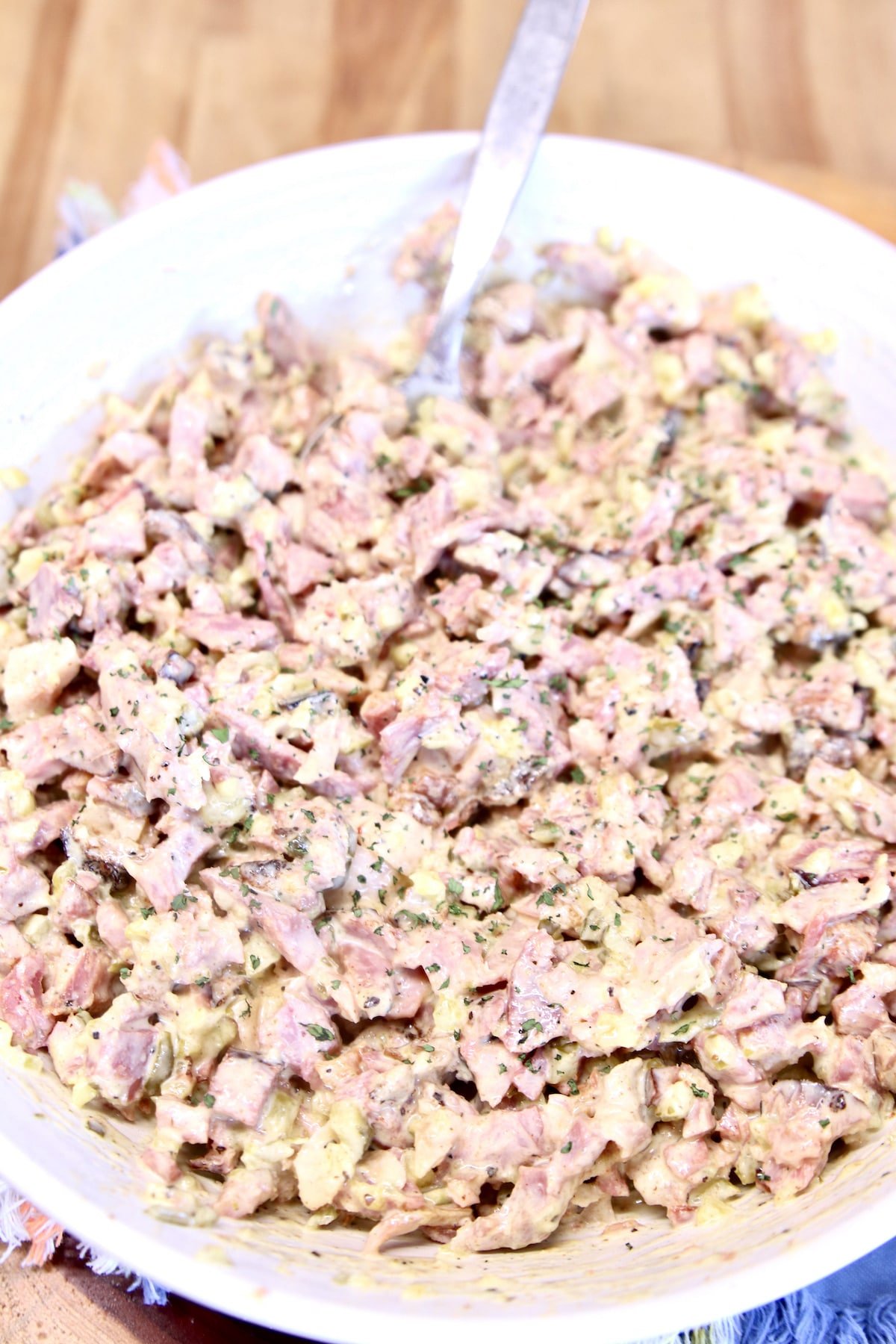 ham salad in a bowl with a spoon.