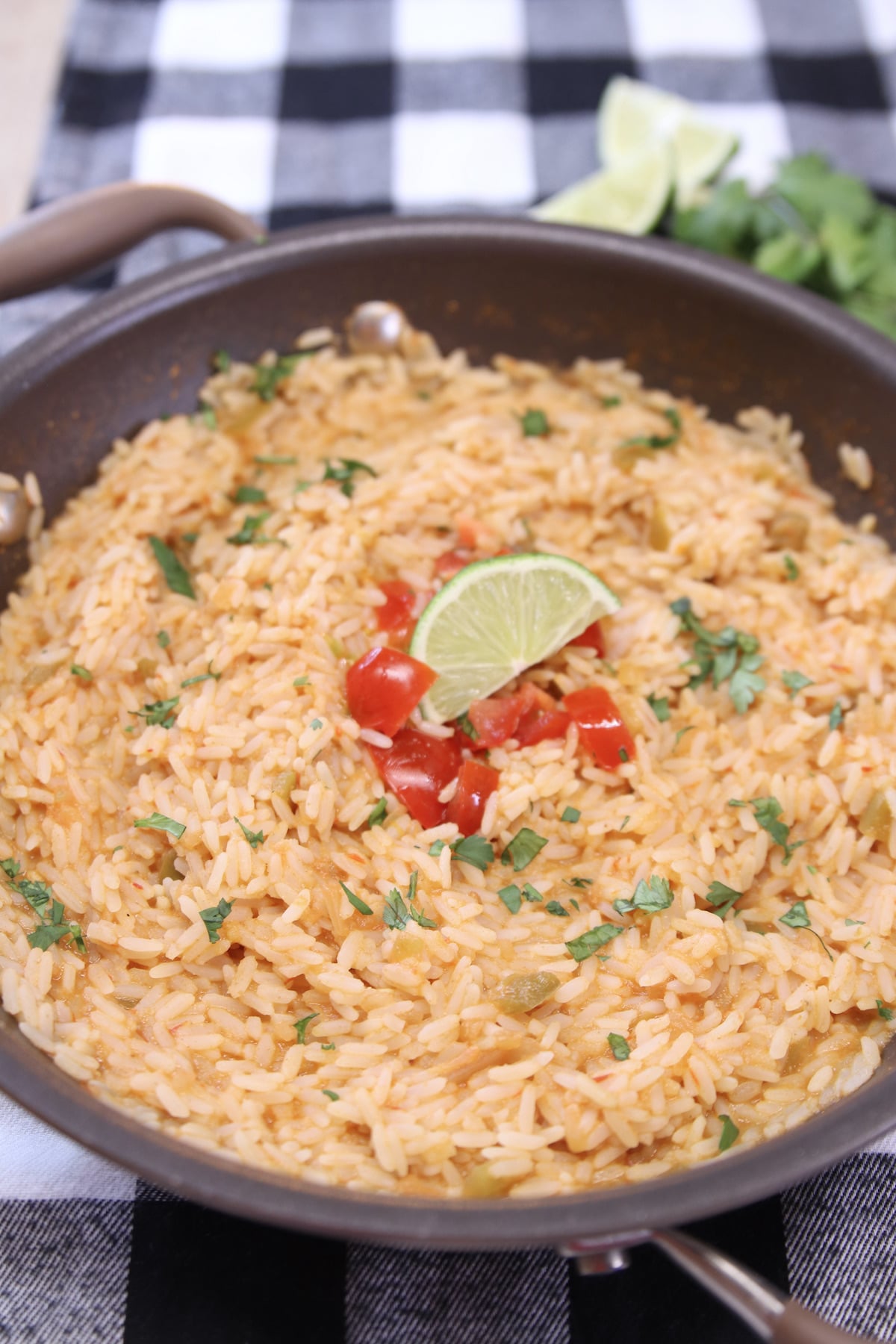 Spanish Rice with tomato and lime garnish.