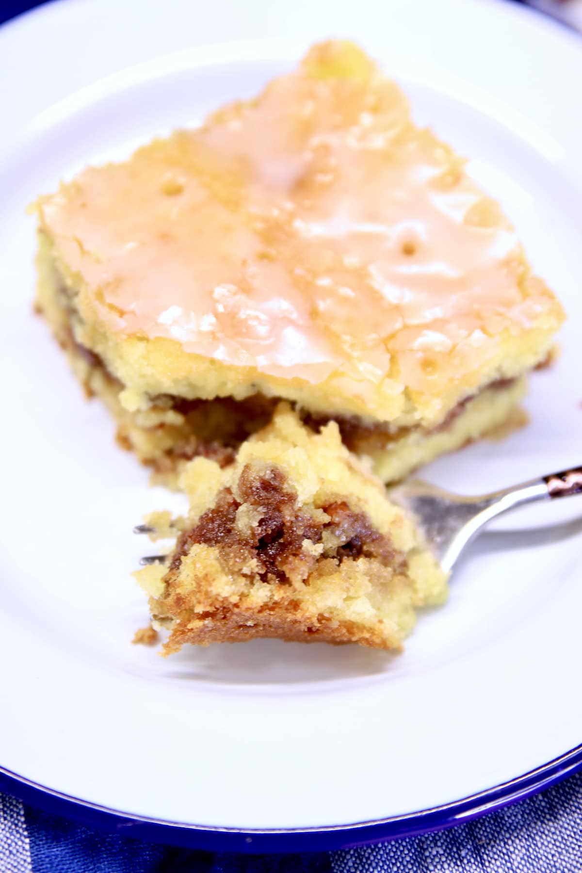 slice of honey bun cake with bite on a fork.