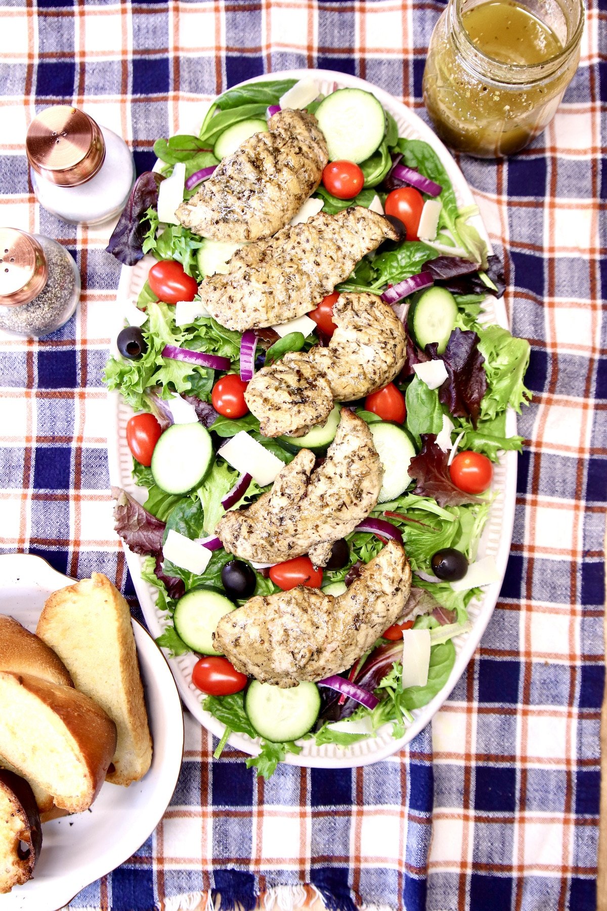 overhead view of platter of grilled chicken tender salad.