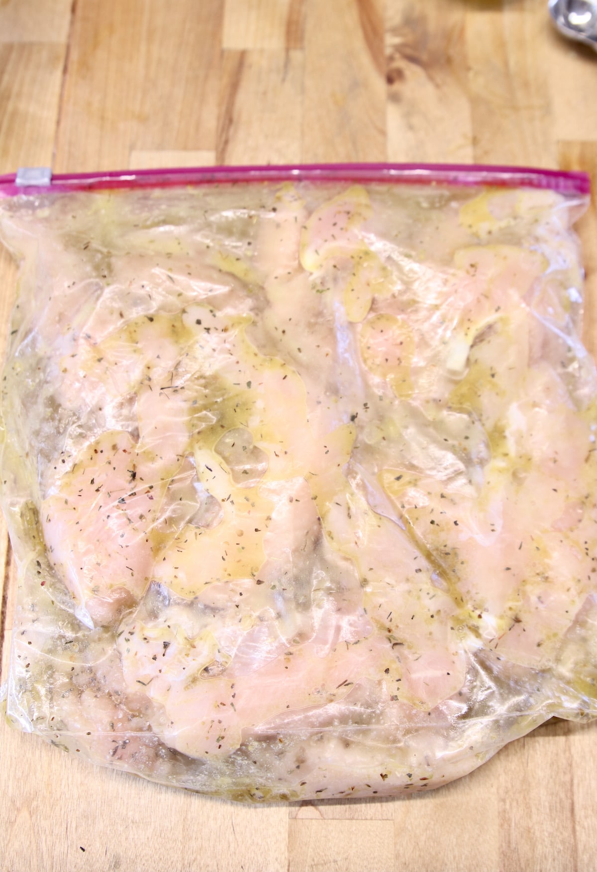 marinating chicken in a zip top bag.