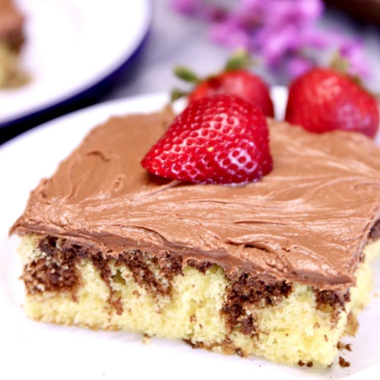 Slice of marble sheet cake with a sliced strawberry on top.