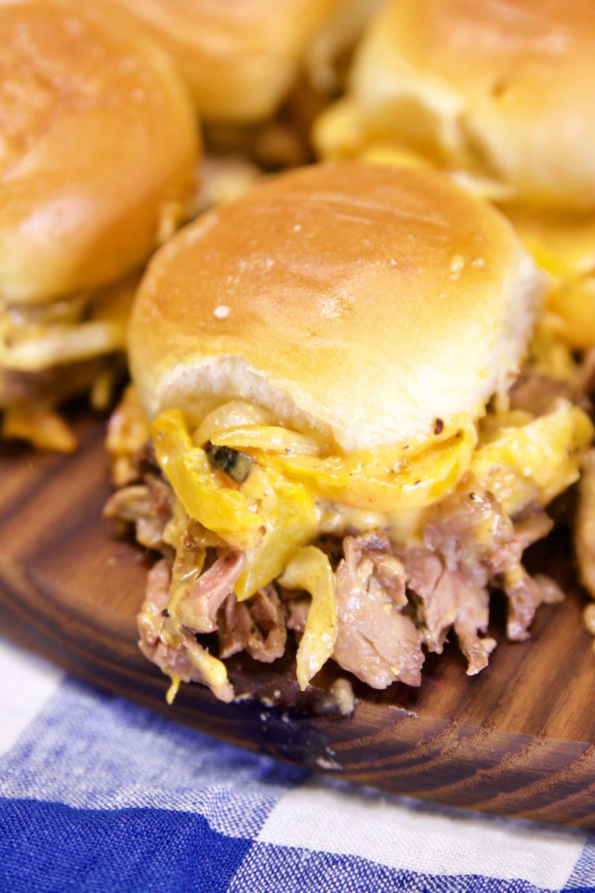 Sliders with steak, peppers, onions and cheese.
