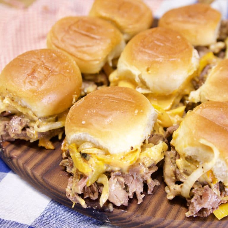 Cheesesteak Sliders on a cutting board.