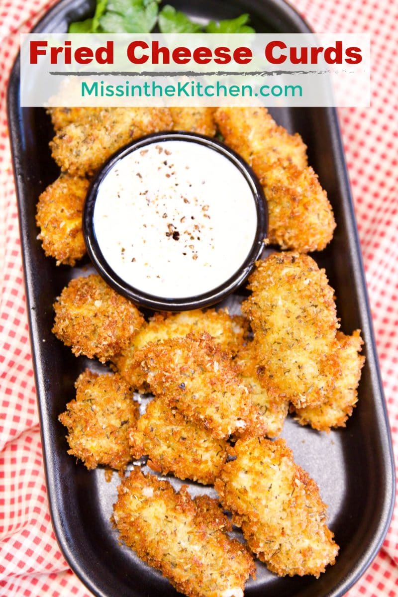 Tray of fried cheese curds with dipping sauce. Text overlay.
