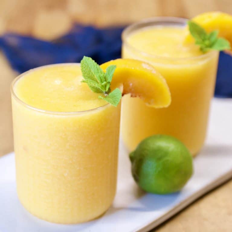 Peach Daiquiris with peach and mint garnish