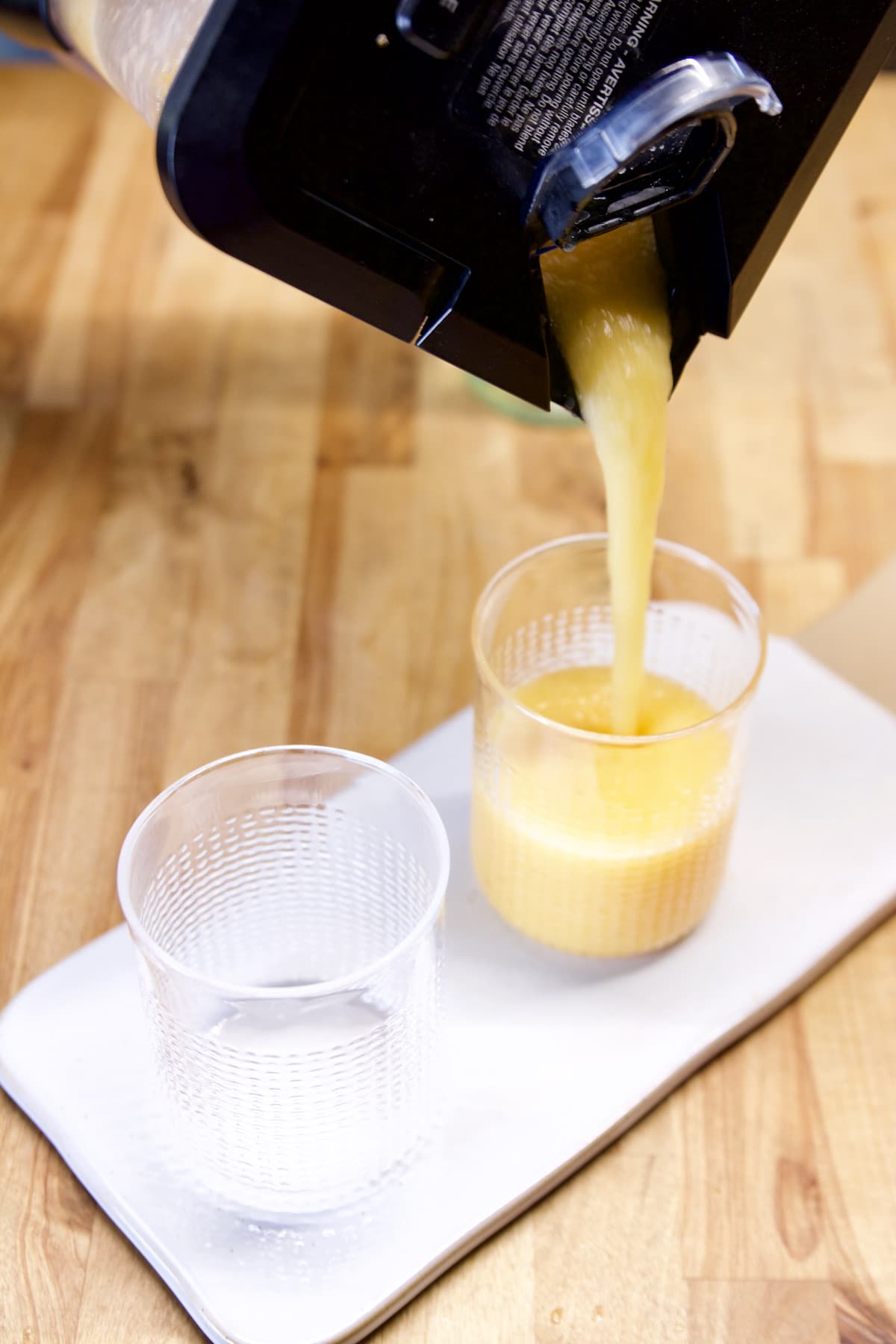 Pouring peach daiquiri into glasses